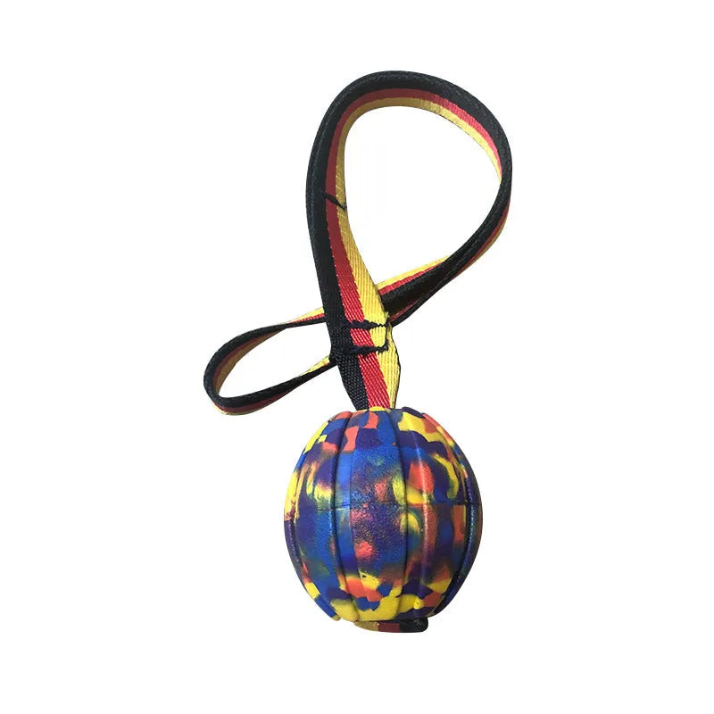 Yellow and camouflage coloured EVA floating dog ball with string in three different sizes on blue background