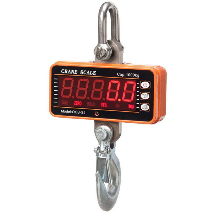 Orange electronic crane scale with digital display for 500 kg loads in warehouse.