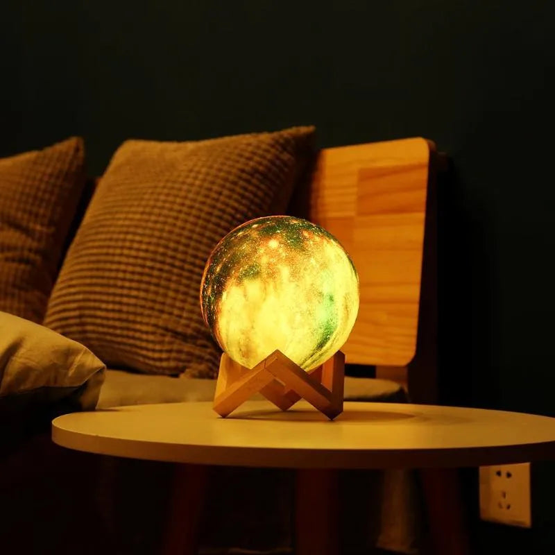3D-printed lunar sphere night light showing colour-changing LEDs with a remote control.
