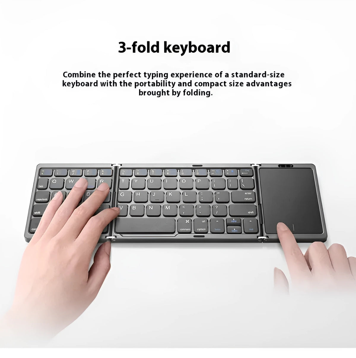 Three folding wireless Bluetooth keyboard with touch pad in black, unfolded on a table