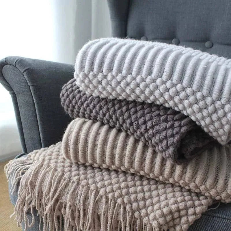 Small grey polyester lap blanket folded, showing its 127 by 170 cm size.