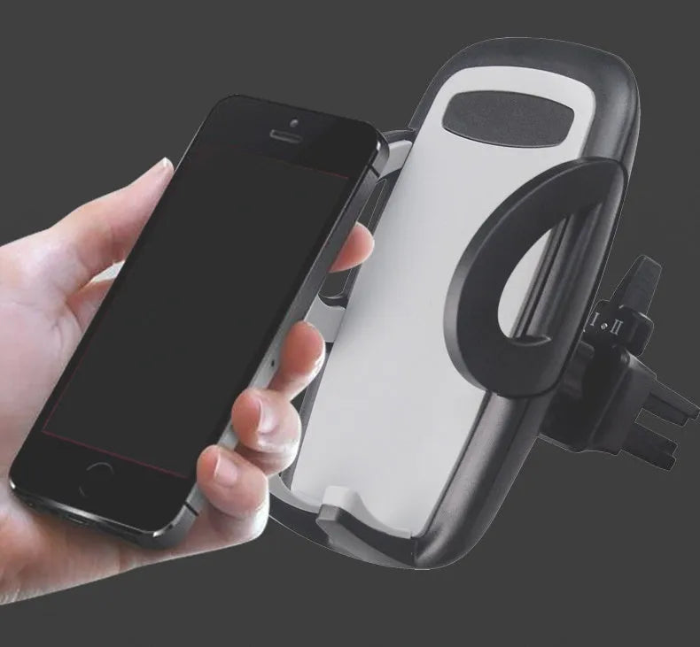 Black plastic universal mobile phone holder attached to a car air conditioning vent.