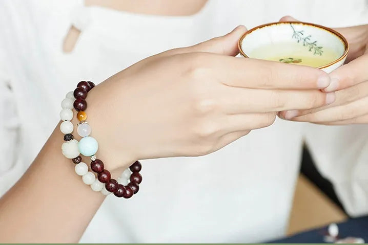 Natural white jade Bodhi bracelet with round beads and transfer bead on white background