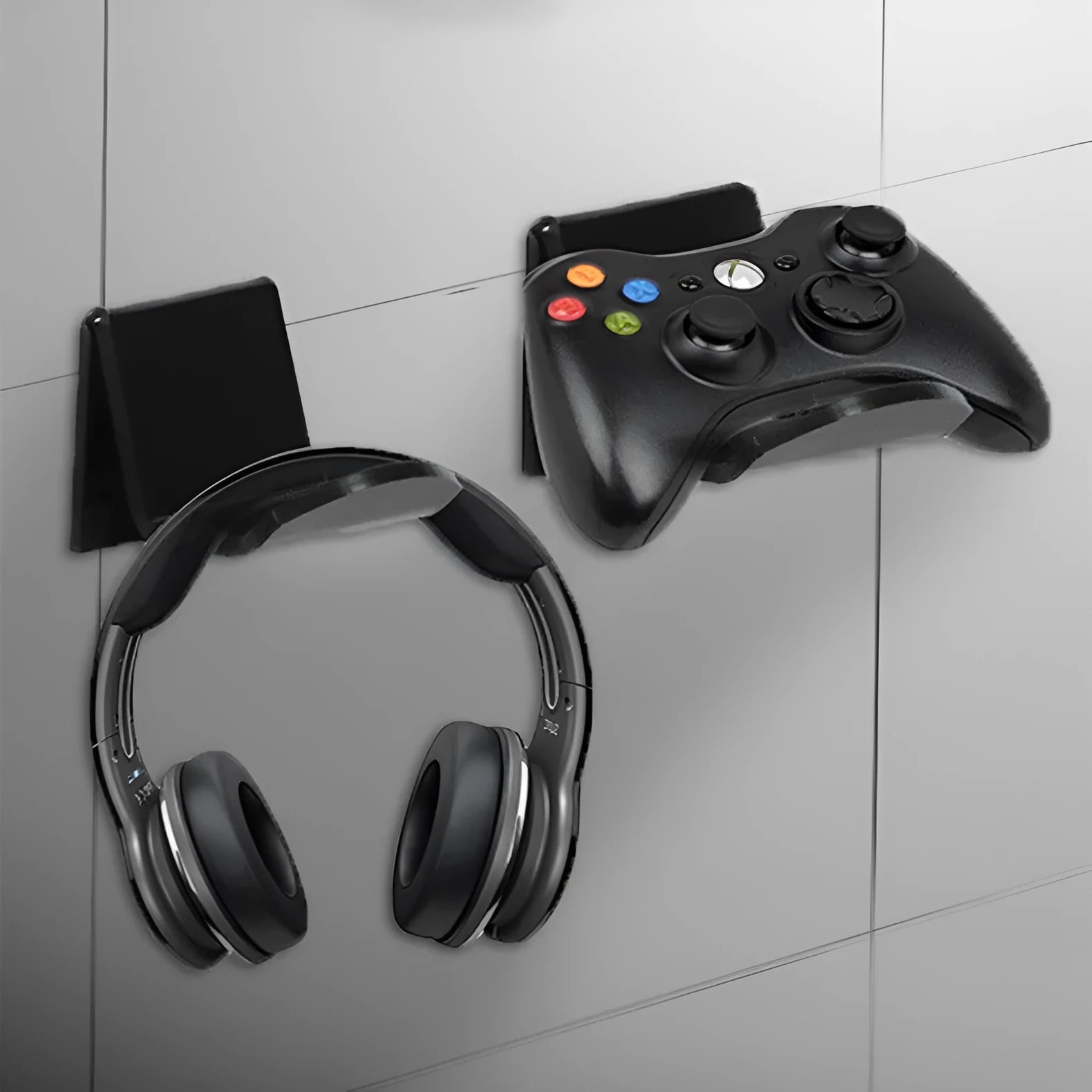 Universal game controller mounting bracket in black colour with nail and adhesive installation options