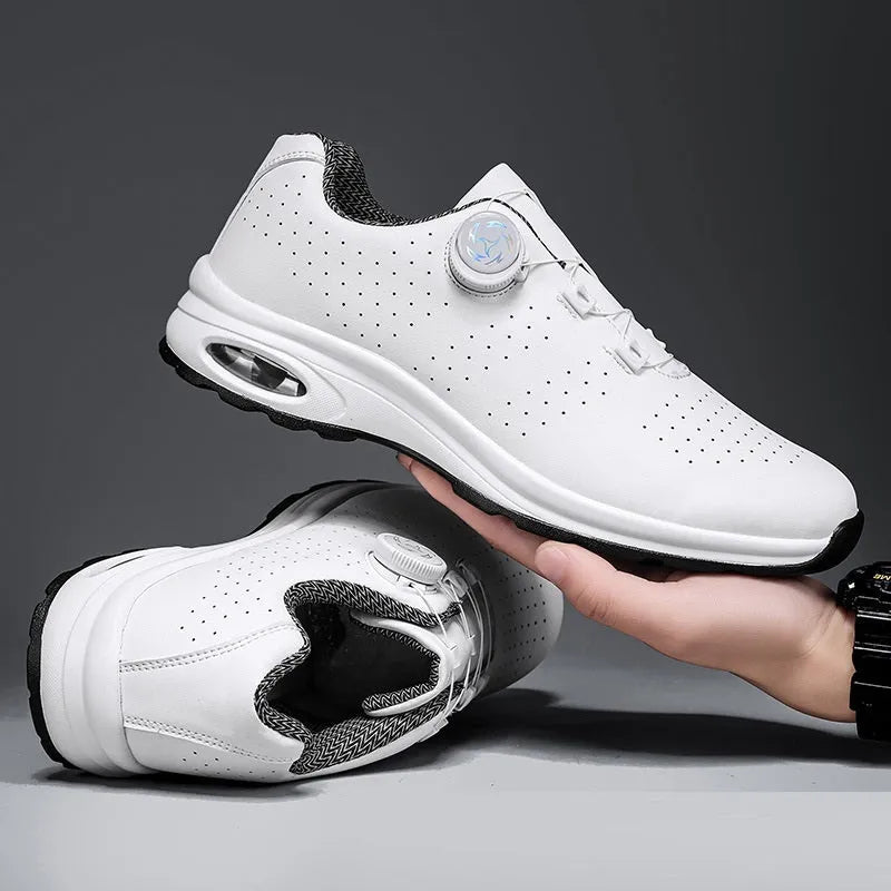 Black and white low-top mesh casual tennis shoes with cross shoulder straps and a flat sole.
