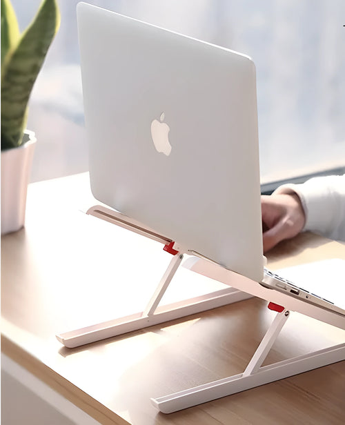 White folding bracket cushion supporting an Apple laptop on a desk.