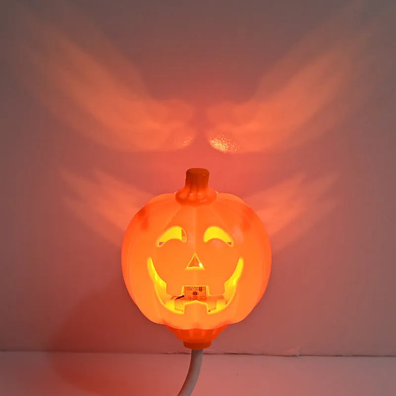 Plastic pumpkin lamp with USB charging cable showing yellow and purple light options