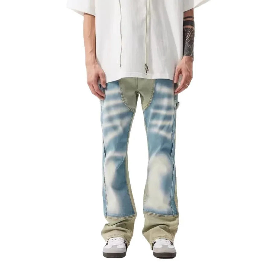 Yellow and blue retro patchwork jeans with splash-ink and distressed detailing on a mid-rise denim fit