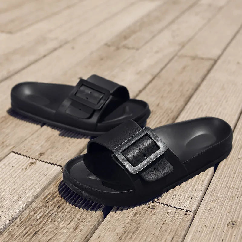 Women's grey blue buckle slipper flip-flops with a soft EVA sole on a plain background.