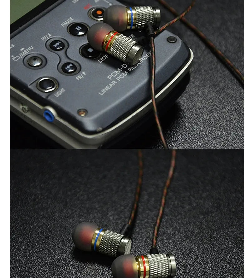 Black wired in-ear headphones with 3.5mm L-bend plug and silicone cable, showing TPE earplugs.