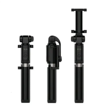 Black Bluetooth selfie stick with tripod base and remote control extended next to smartphone