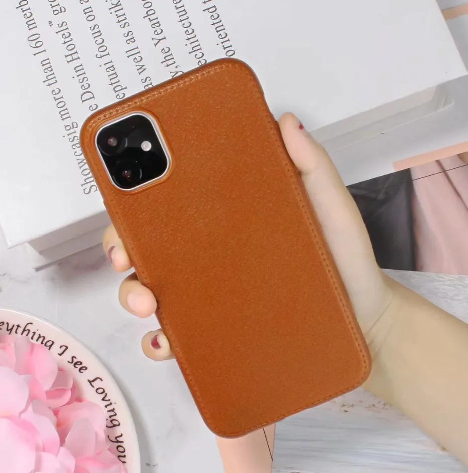 Genuine leather phone case for Apple iPhone in black, shown fitted to an iPhone 11 model.