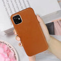 Genuine leather phone case for Apple iPhone in black, shown fitted to an iPhone 11 model.