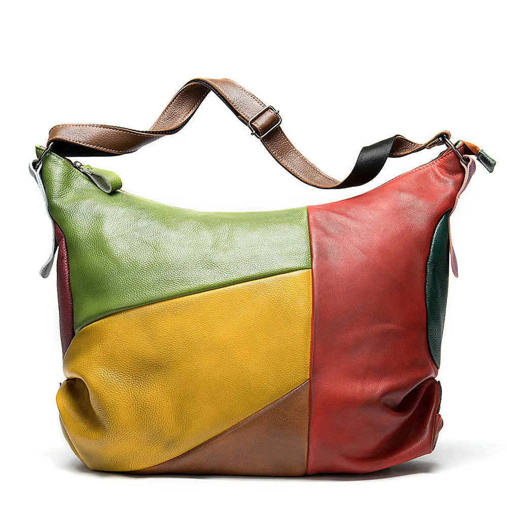 Brown cowhide leather travel bag shown as a crossbody style, with stitching details and enough space for a laptop and magazines.