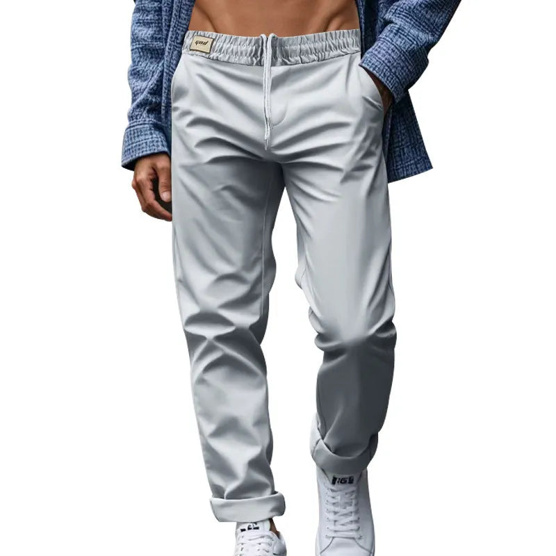 Men's loose fit drawstring trousers in solid colour Beige, side view showing straight leg and mid-waist drawstring closure.