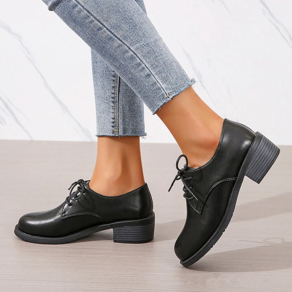 Black women's work shoes with thick rubber heel and soft sole, low top design with European styling