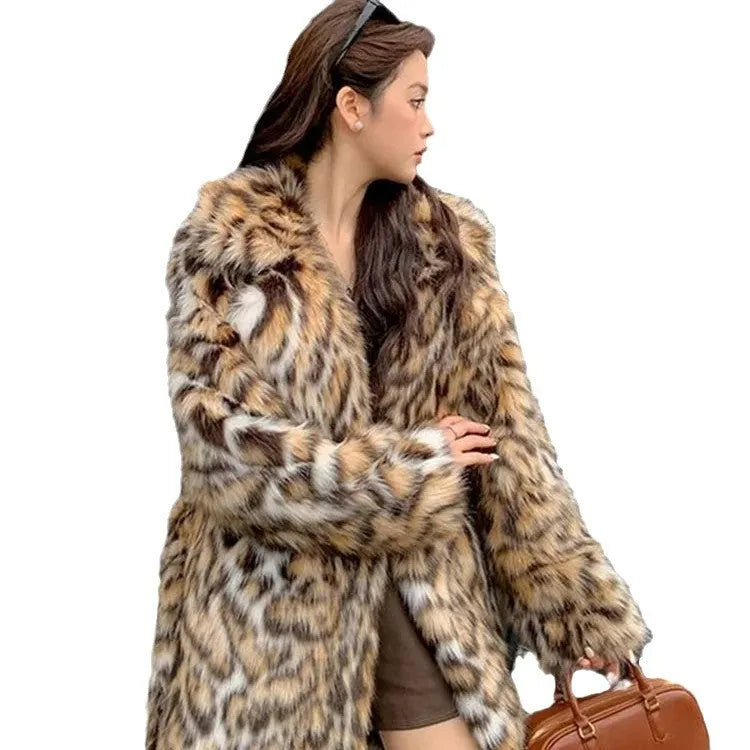 A person wearing a grey faux fur coat with a large fur collar and front pockets, in a street-fashion style.