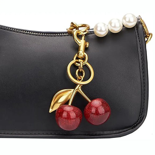 Three-dimensional red zinc alloy cherry pendant charm on a key ring.
