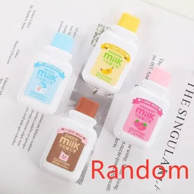 A cute, patterned bottle-shaped correction tape dispenser with a curved design, shown on a paper surface.