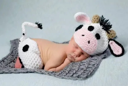 Hand-knitted white baby cow suit with matching pants and hat for newborns