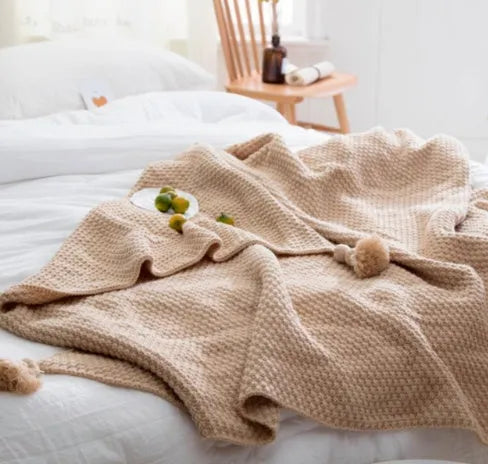 Nordic-style fringed knit acrylic blanket in beige, measuring 130 by 170 centimetres.