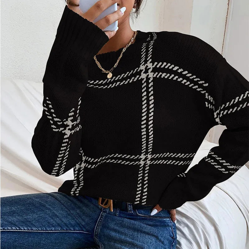 Women's loose fit plaid sweater with apricot, black, beige, red, and green colour-block stripes.