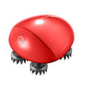 Red handheld scalp massager with silicone nodes measuring 110x120x82mm