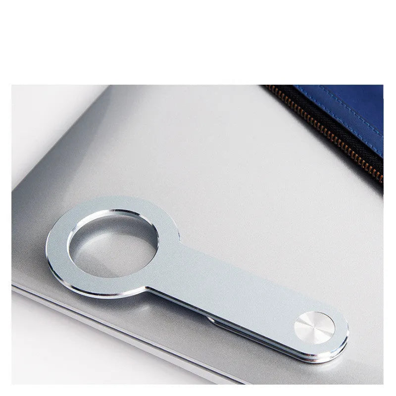 Metallic silver aluminium alloy mobile phone holder for Apple iPhone on a desk