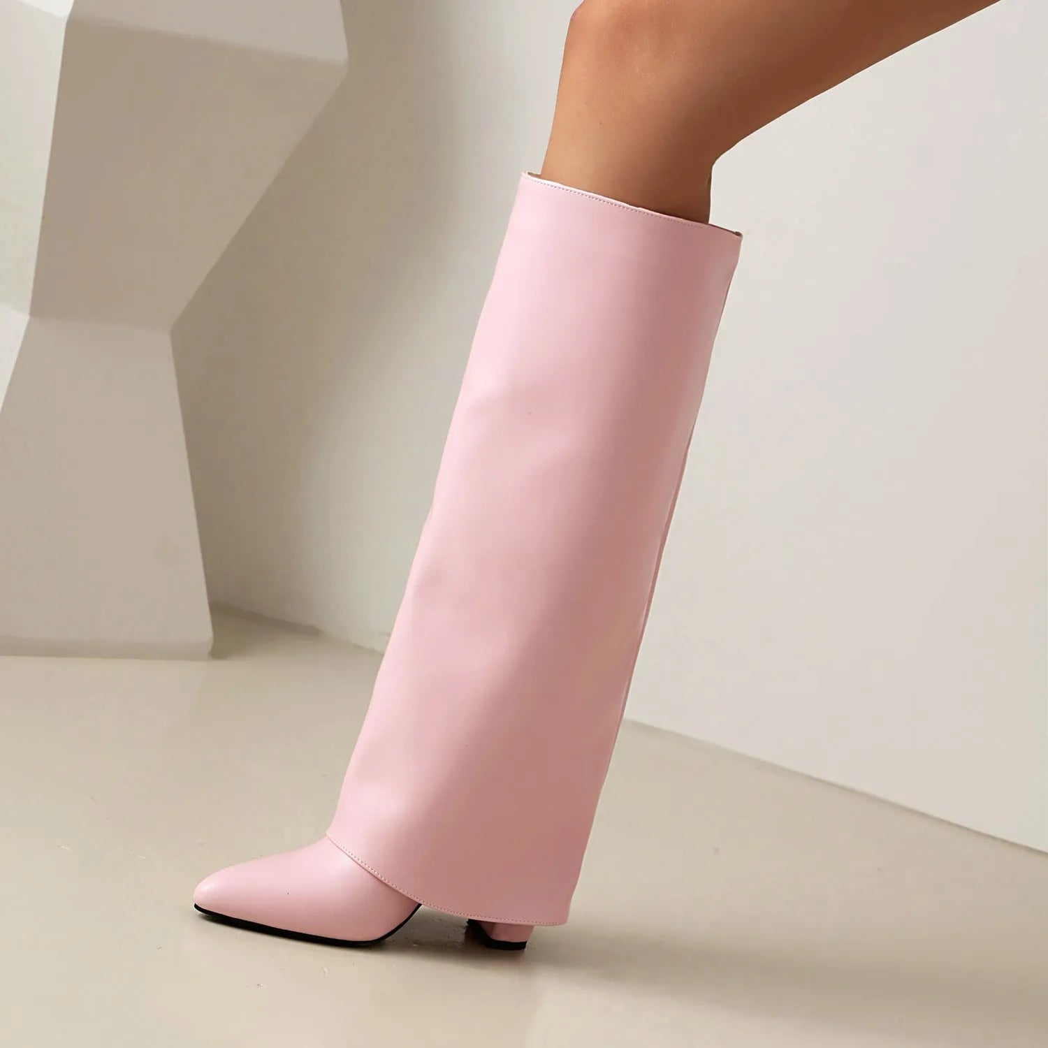 Women's plus size black PU leather knee-high boots with high heel and sewn detail line.