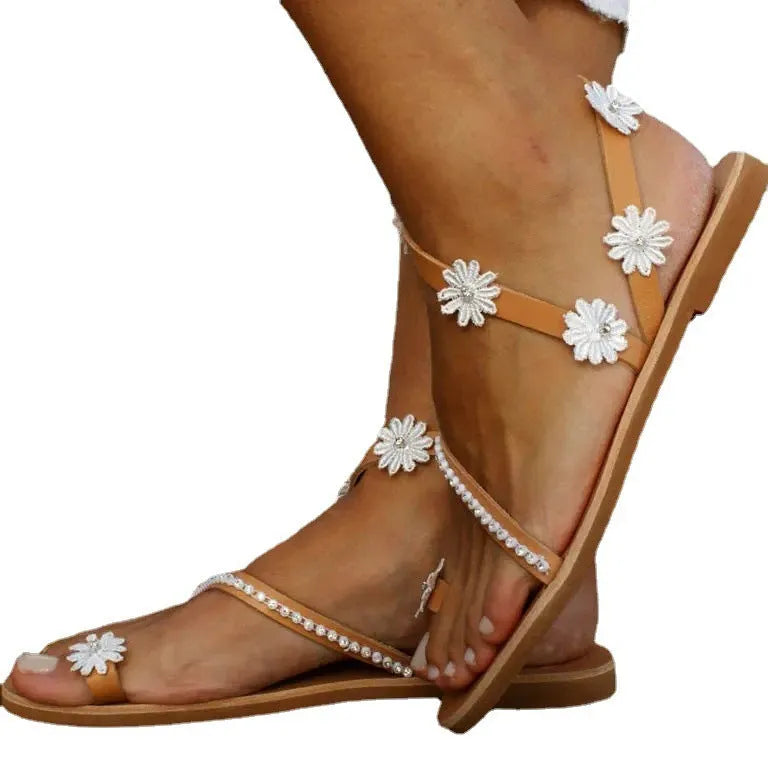Brown women's flat Roman sandals with floral pattern on the artificial PU upper.
