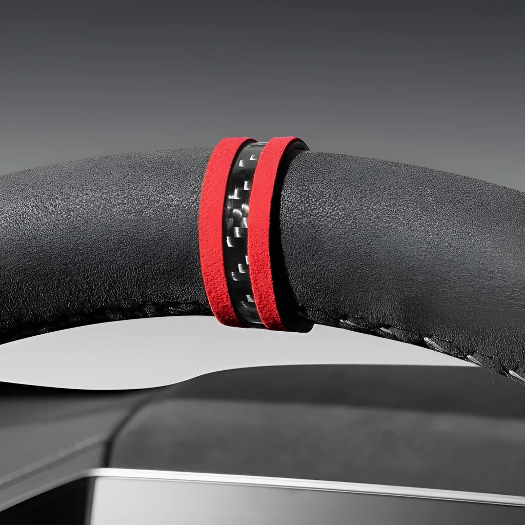 Suede steering wheel cover with carbon fibre back in multiple colour options on a car steering wheel.