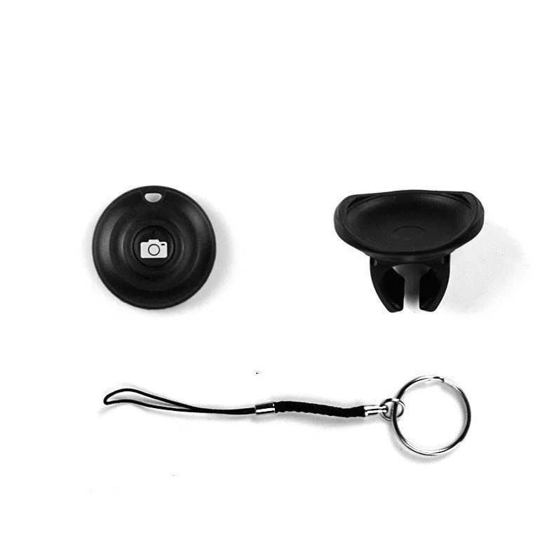 Small black Snap Bluetooth remote control for wireless smartphone camera photos on a white background.