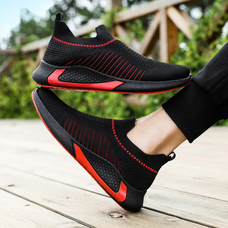 Men's low-cut sneakers with striped Flyknit upper, mesh lining, and flat plastic sole.