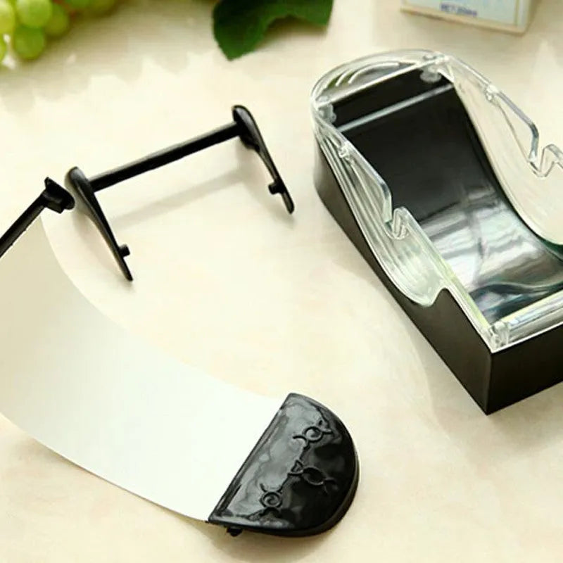 Black DIY plastic kitchen roll sushi machine on a flat surface with lever and roller band visible