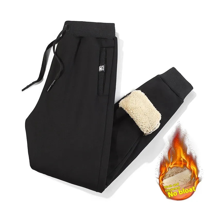 Men's grey fleece-lined cotton oversized track pants with a straight leg, laid flat.
