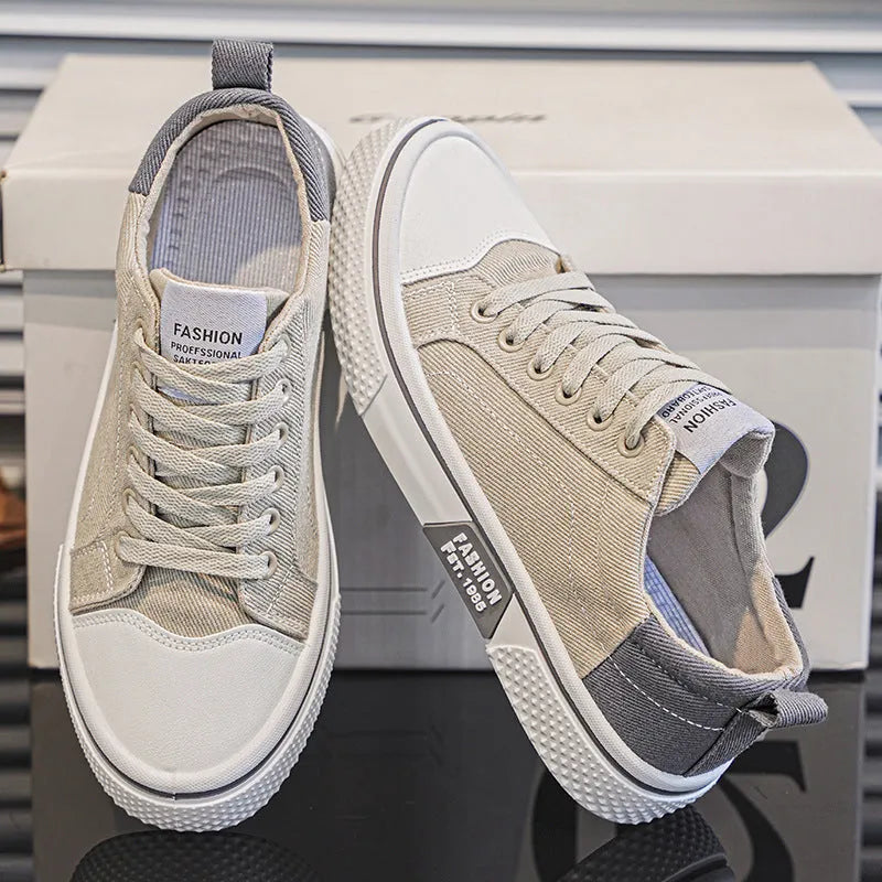 Men's low-top canvas shoes in blue with white sole and lace-up front, on a grey background.
