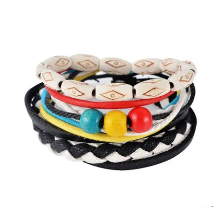 Handmade brown leather wrap bracelet with wooden beads and braided cord on a wrist.