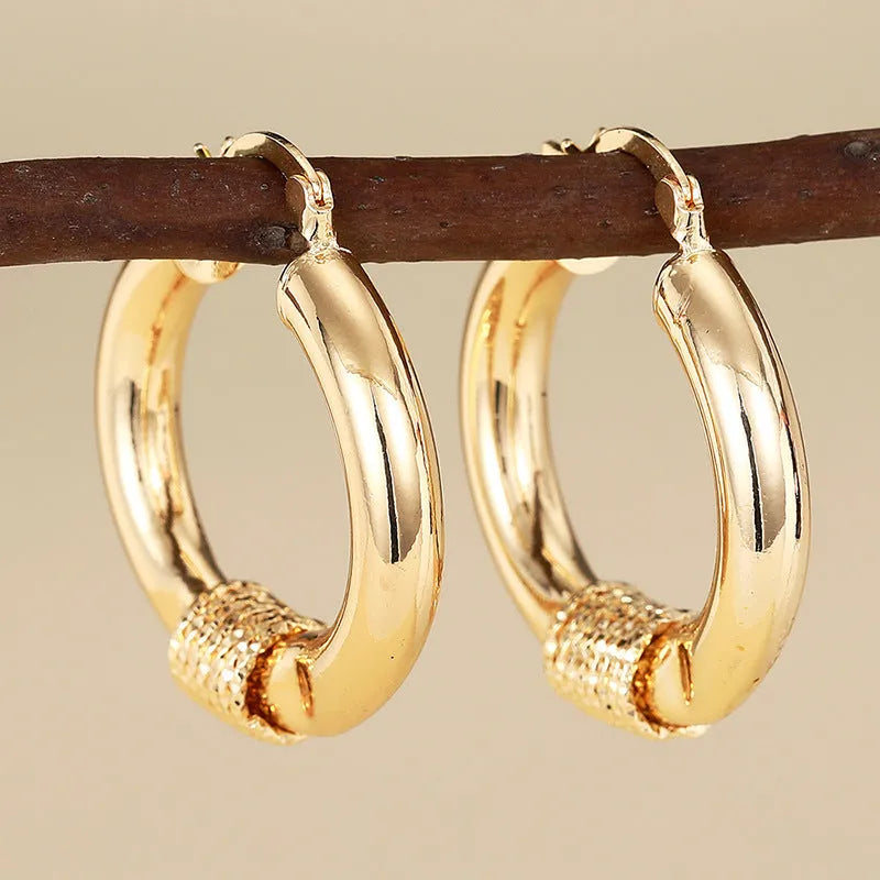 Geometric copper ring ear clip earrings in golden finish with linear design details