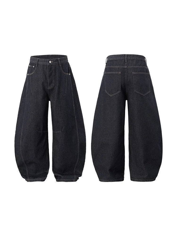 Men's wide leg denim trousers in original cow colour, laid flat to show mid-waist and relaxed fit.