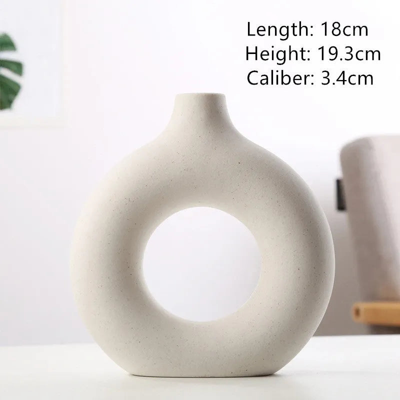 Frosted unglazed porcelain biscuit vase in a simple modern style on a table.