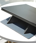 Blue foldable laptop cooling stand with anti-slip surface, shown open and closed, next to a laptop.