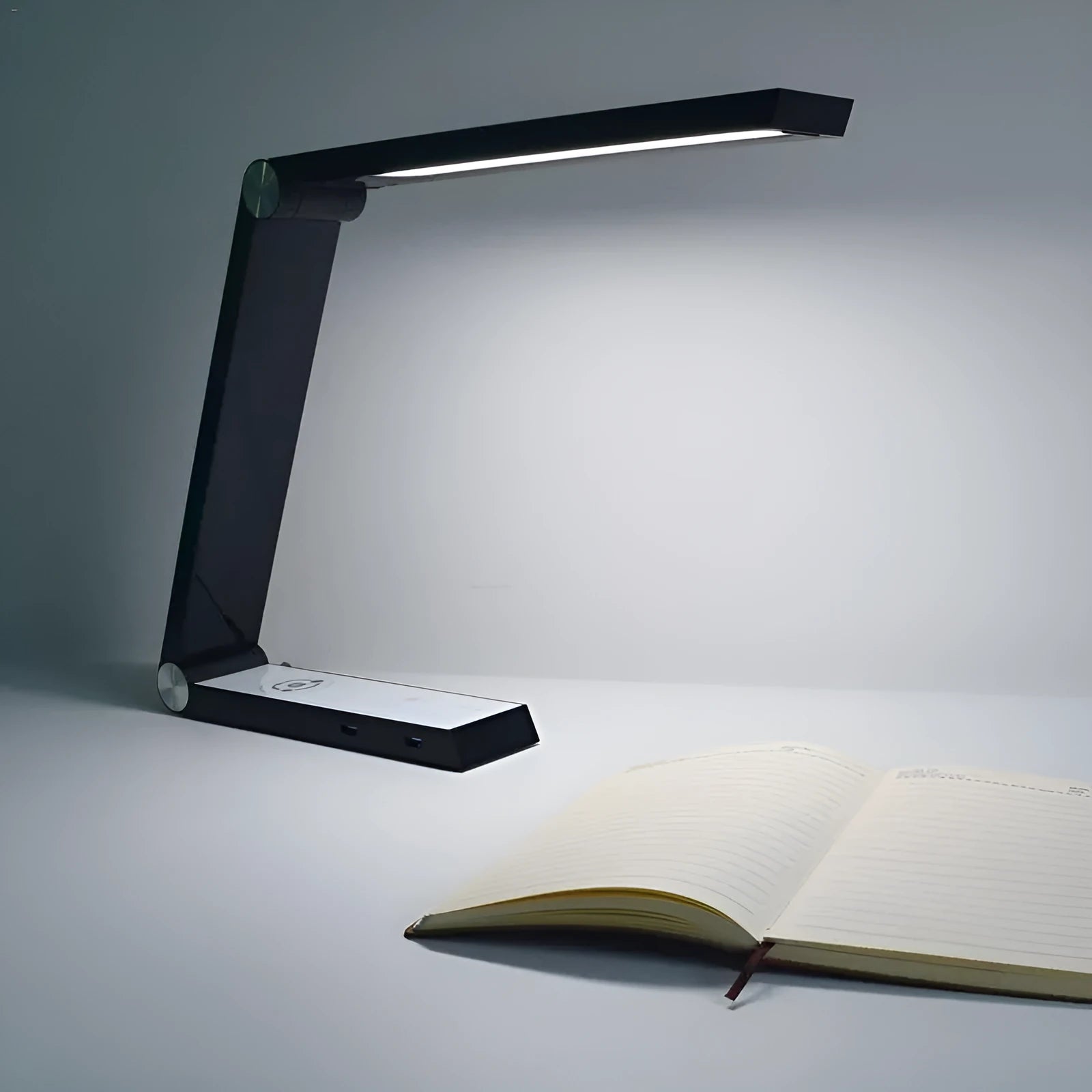LED triangle table lamp with wireless charging pad and touch dimming controls in black