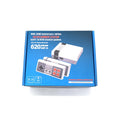 NES 8-bit retro game console with two controllers, power supply, and AV cable on a table.