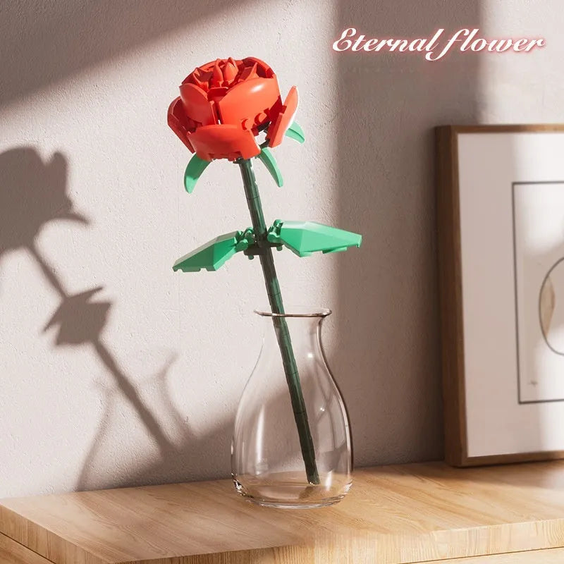 Rose assembled from small particle plastic building blocks in pink, red, or blue