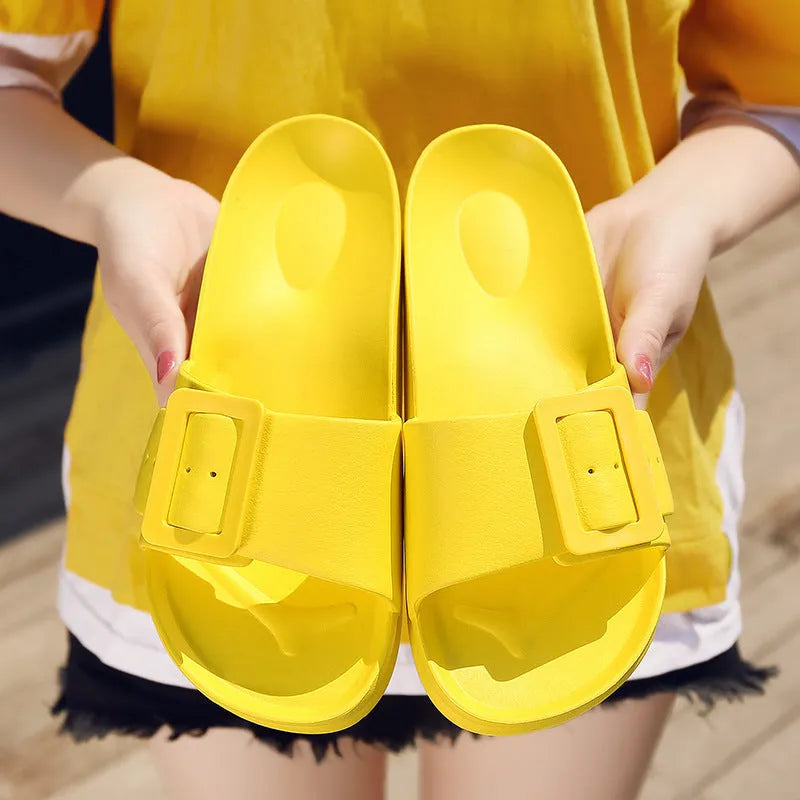 Women's grey blue buckle slipper flip-flops with a soft EVA sole on a plain background.