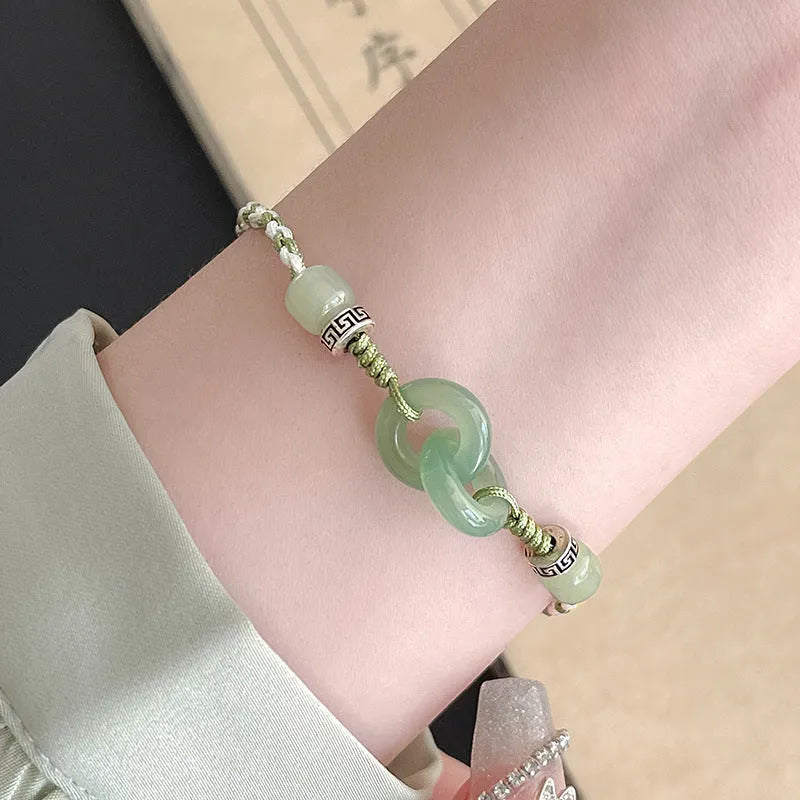Women's green and copper ethnic-style bracelet with jade buckle weaving and a peace buckle charm.