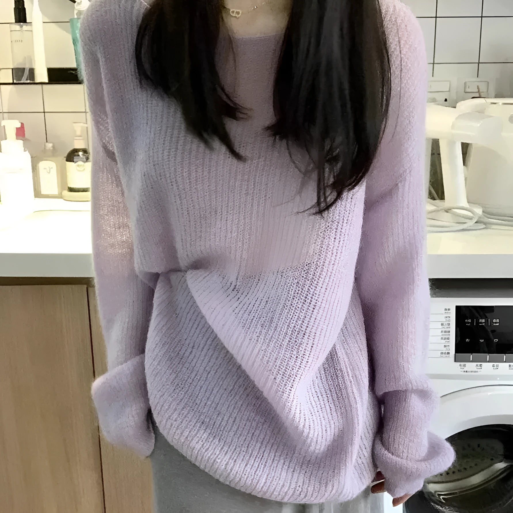 Purple women's sleeveless sweater with hollow-out design and shoulder strap detail.