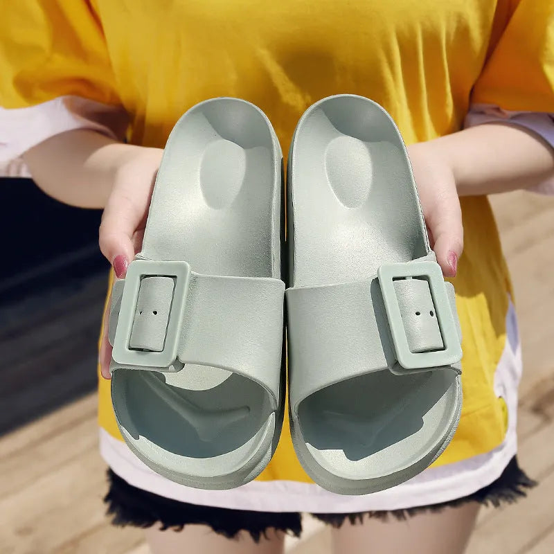 Women's grey blue buckle slipper flip-flops with a soft EVA sole on a plain background.