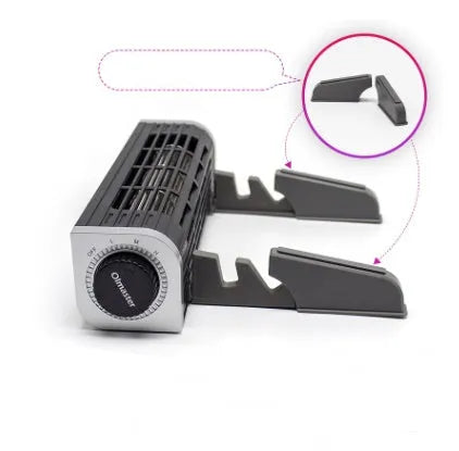 Black notebook cooler with two fans, a USB cable, placed under a silver laptop on a desk.