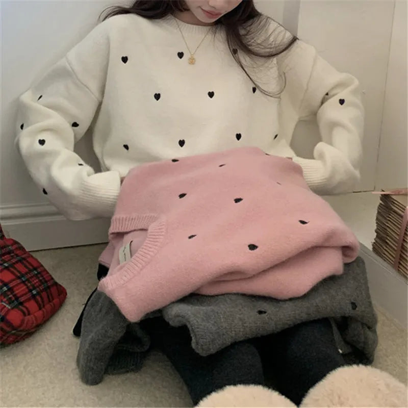 Beige women's loose knit acrylic cardigan with embroidery on the front, featuring long sleeves and a crew neck.